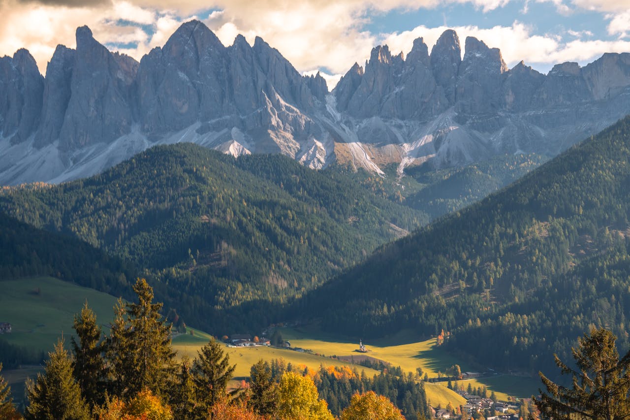 services-01 Breathtaking view of the Dolomites with autumn foliage and clear skies.